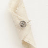 The talara sun ring styled on rolled linen