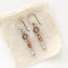 The talara sun zaria earrings styled on tan linen