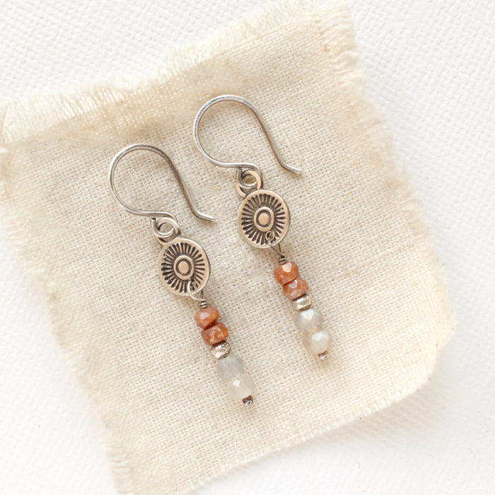 The talara sun zaria earrings styled on tan linen