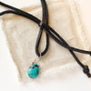 The turquoise drop adjustable leather necklace styled on tan linen
