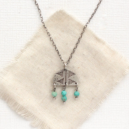 The turquoise fringe pakal arch necklace styled on tan linen