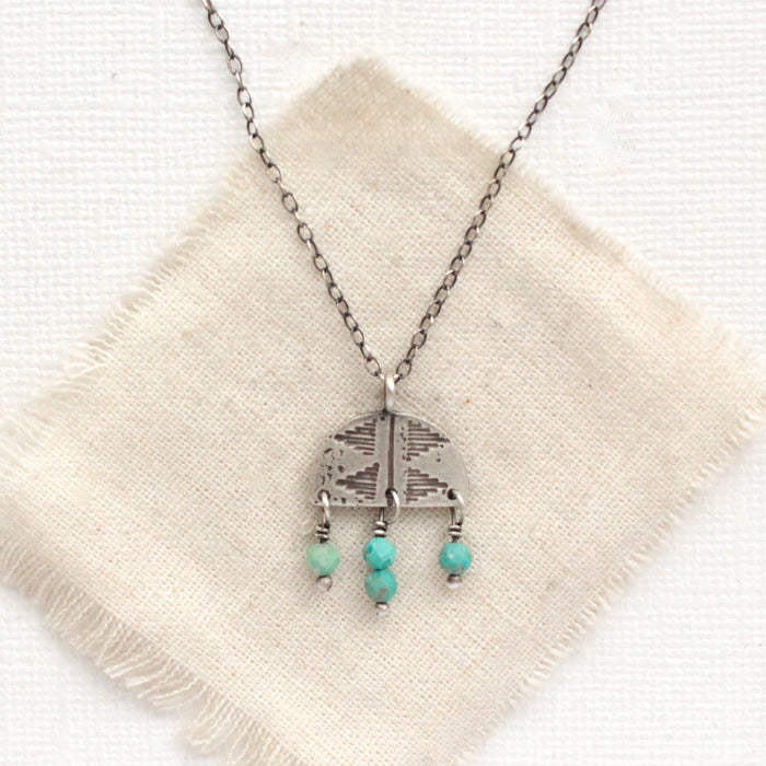 The turquoise fringe pakal arch necklace styled on tan linen