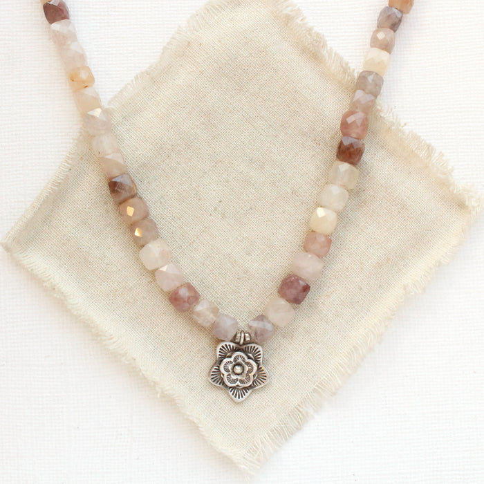The layered cactus flower violet jade necklace styled on tan linen