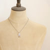 A mannequin wearing the wanderer arch mixed metal labradorite necklace