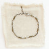 The wrapped pyrite bracelet styled on tan linen