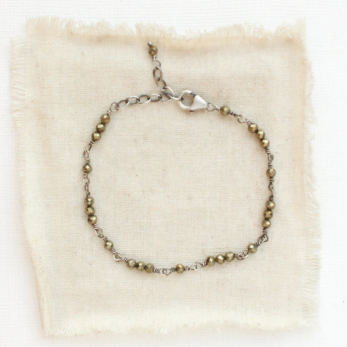 The wrapped pyrite bracelet styled on tan linen