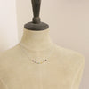 A mannequin wearing the wrapped silver rainbow necklace