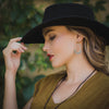A model wearing the feathered hoop earrings