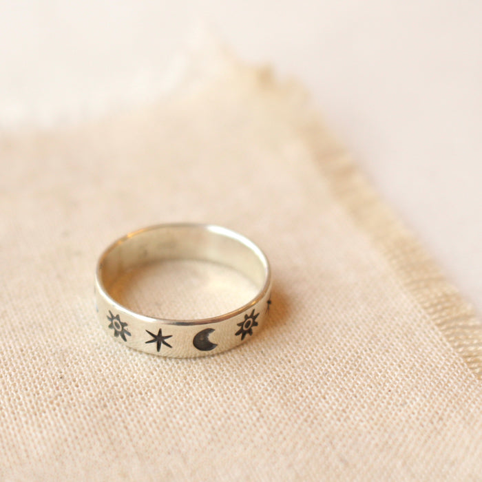 The celestial stamped ring styled on tan linen
