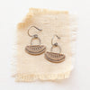 The asmi short loop bronze and silver earrings styled on tan linen