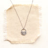 midnight bloom necklace on tan linen