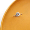 The little mixed metal sun ring styled on a yellow plate