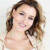 A model wearing the mixed metal triple triangle hoop earrings
