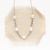 The oxidized silver pearl bud vine necklace styled on tan linen