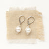 The perfect pearl silver wrapped earrings styled on tan linen