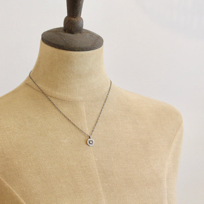A mannequin wearing the rustic sun necklace