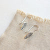 The stamped silver feather lobe huggers showing the lobe hugger earwires